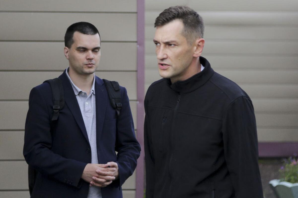 Oleg Navalny, right, brother of Alexei Navalny, arrives Friday at a Russian hospital where Alexei is being treated.