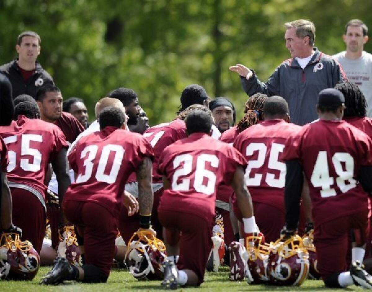 Washington Redskins Coach Mike Shanahan talks to players at rookie camp on May 5.