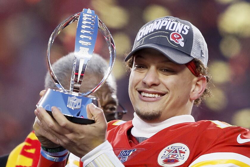 Kansas City Chiefs quarterback Patrick Mahomes holds up the Lamar Hunt Trophy after Sunday's victory in the AFC Championship Game.