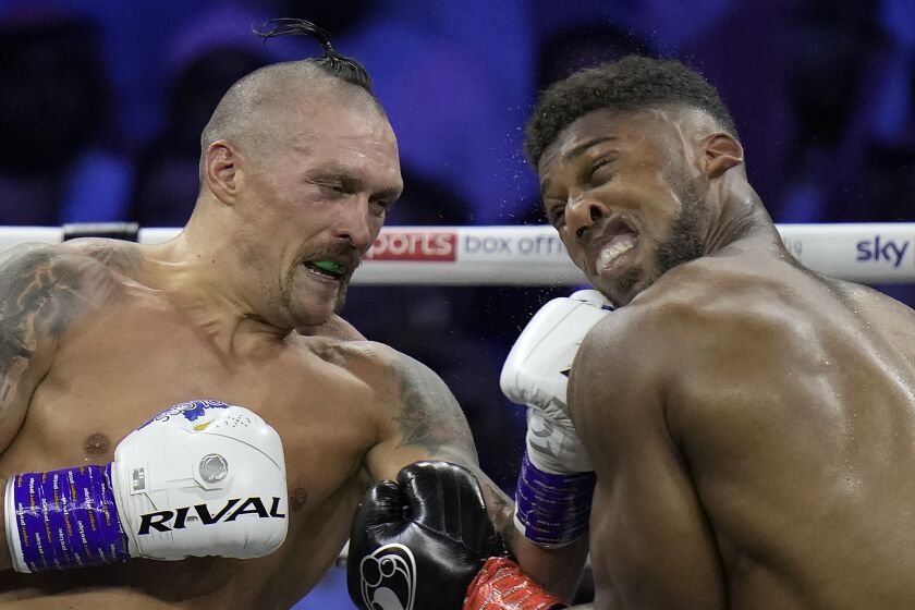 FILE - Britain's Anthony Joshua, right, takes a blow from Ukraine's Oleksandr Usyk during their world heavyweight title fight at King Abdullah Sports City in Jeddah, Saudi Arabia, Sunday, Aug. 21, 2022. Anthony Joshua has been facing a new reality in recent months. He has been the poster boy of boxing’s heavyweight division for so long but suddenly the British fighter is on the outside looking in. (AP Photo/Hassan Ammar, File)