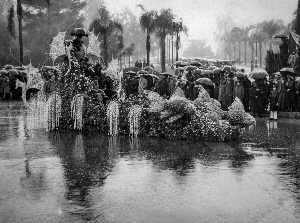 Jan. 1, 1934: Tournament of Roses queen Treva Scott, at the top of the float with an umbrella, and her court during a rainstorm.