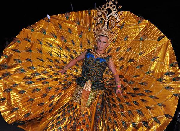 A Thai drag queen displays his elaborate peacock costume during the 31st annual Gay and Lesbian Mardi Gras parade.