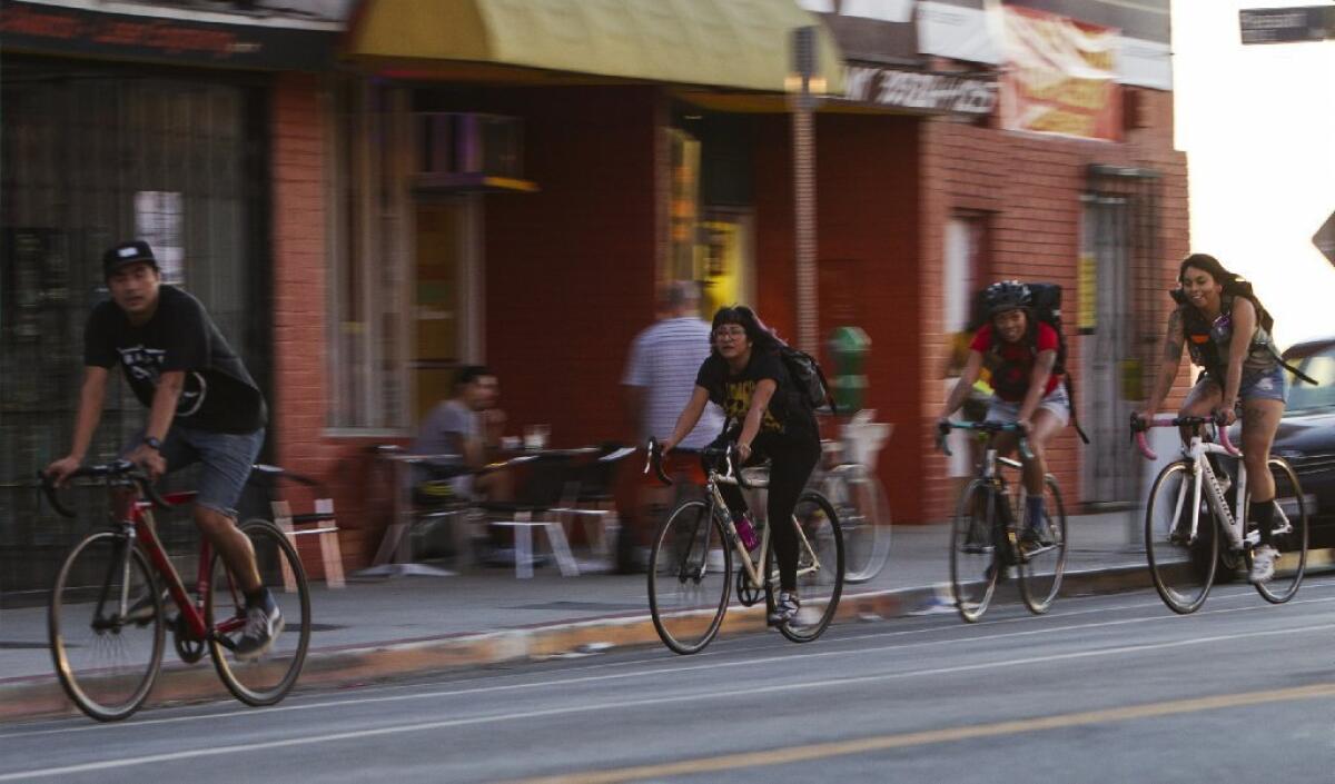 Bicyclists on 1st Street across from Mariachi Plaza in East Los Angeles, where city officials are considering more bike lanes to accommodate a growing number of two-wheeled commuters and pleasure riders.