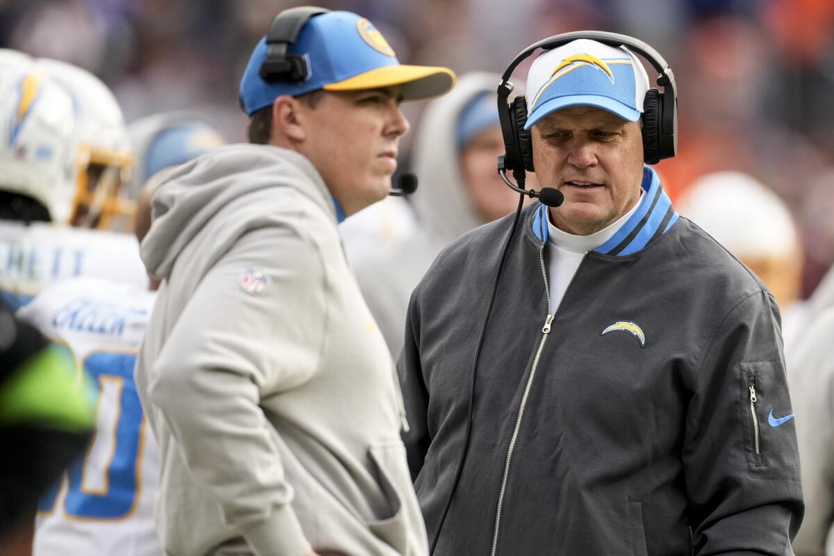 Chargers coach Giff Smith, right, and offensive coordinator Kellen Moore walk during a game against the Denver Broncos.