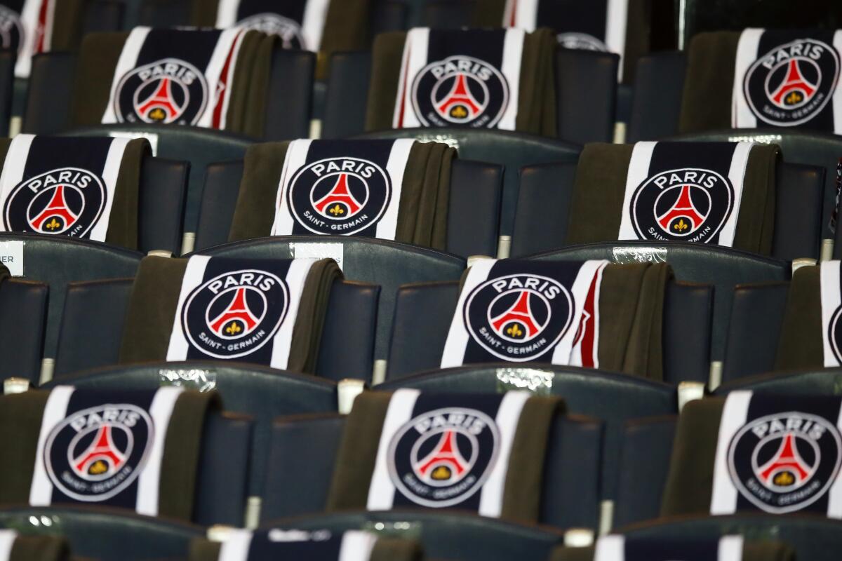FILE - The logos of the Paris Saint Germain are displayed on the seats of the VIP stands prior to the Champion's League round of 16, first leg soccer match between Paris Saint Germain and Barcelona at the Parc des Princes stadium in Paris, Tuesday, Feb. 14, 2017. Paris Saint-Germain has defended its use of chartered flights rather than more ecological trains after an executive for France's high-speed rail network called out the club for flying its players on a short-haul to Nantes Saturday Sept.4 2022. (AP Photo/Francois Mori,File)