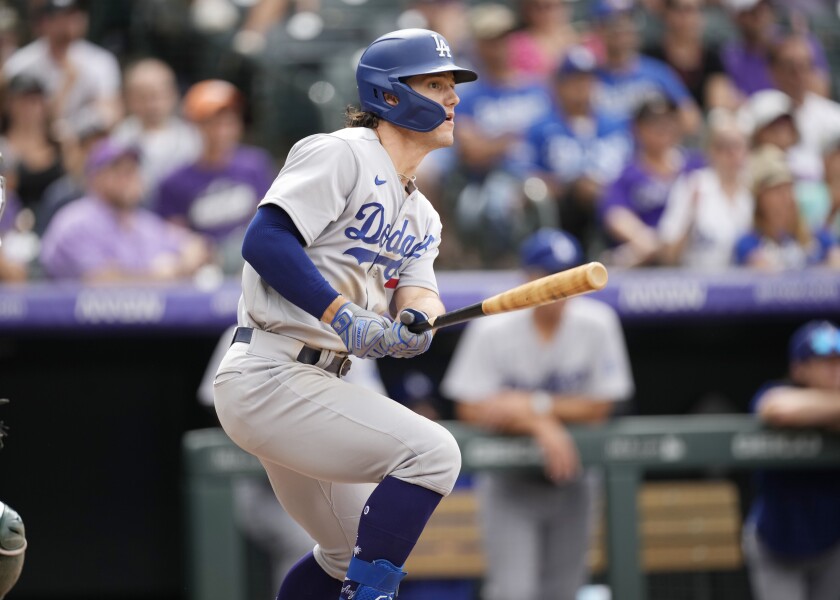 Dodgers outfielder James Outman hits a RBI double against the Colorado Rockies in the eighth inning Sunday.