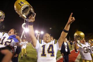 UCLA quarterback Drew Olson (14) celebrates a 30-27 overtime win over Stanford on Saturday.