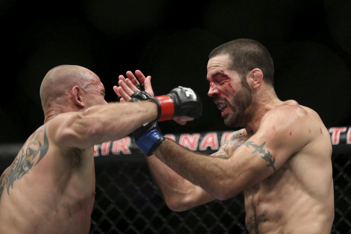 Donald Cerrone, left, battles Matt Brown during their bout at UFC 206 in Toronto.