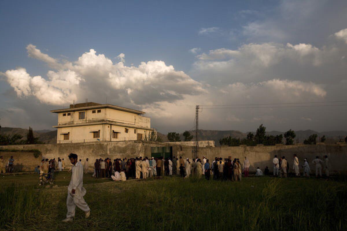 Residents gather outside the compound where Osama bin Laden was killed in an operation by Navy SEALs.