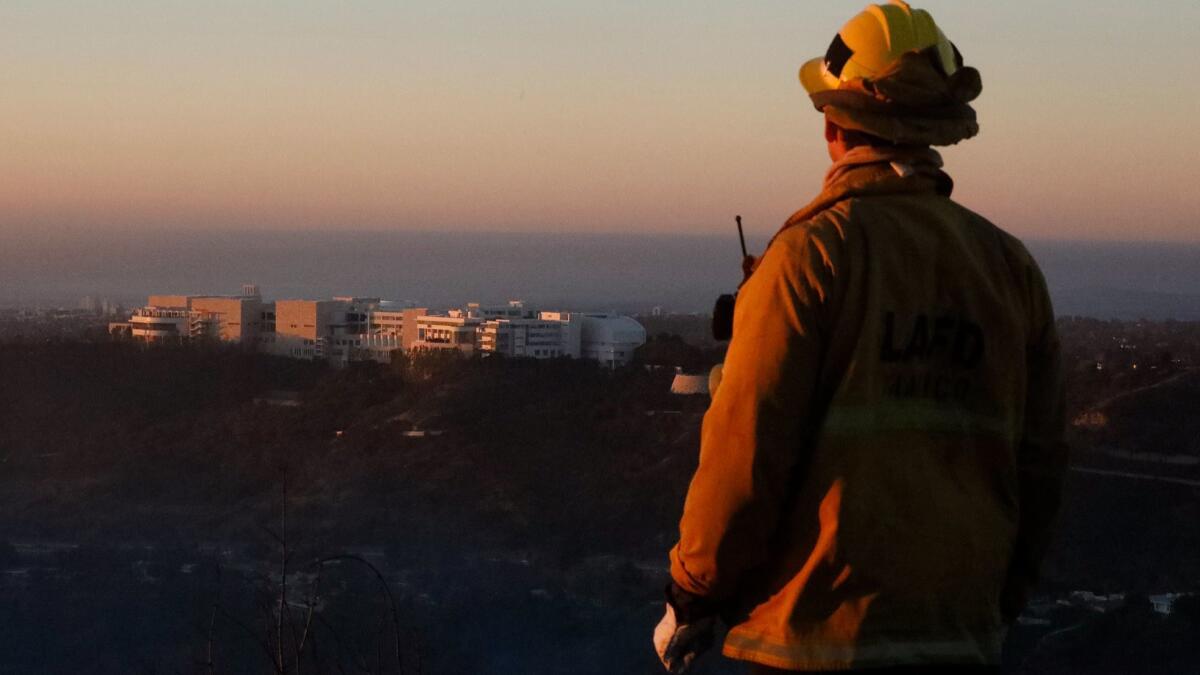 Firefighter Bobby D'Amico looks out over the Getty Center while monitoring the Skirball fire.