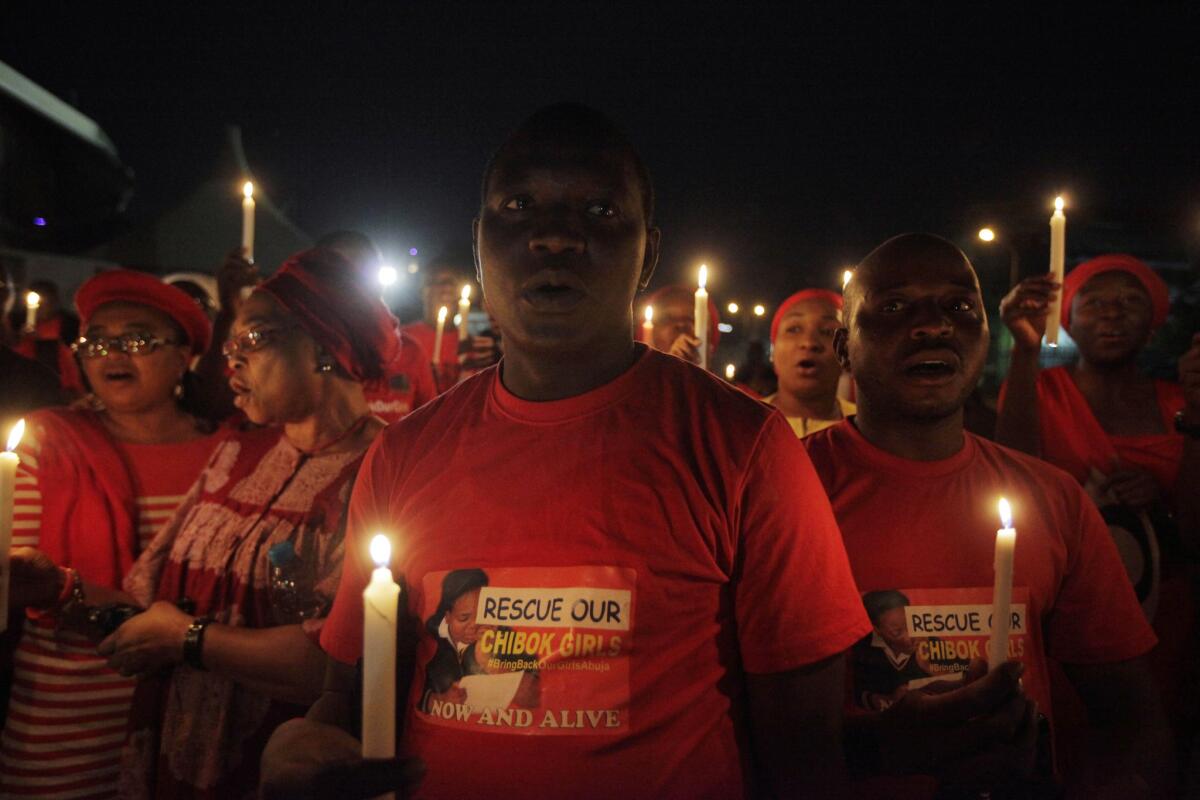 Demonstrators in the Nigerian capital, Abuja, hold a candlelight vigil this week to mark a month of captivity for scores of kidnapped schoolgirls.