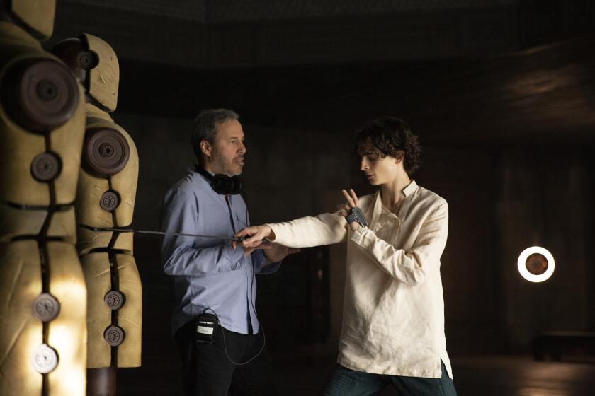 Caption: (L-r) Director/co-writer/producer DENIS VILLENEUVE and TIMOTHEE CHALAMET on the set of Warner Bros. Pictures' and Legendary Pictures' action adventure "DUNE," a Warner Bros. Pictures and Legendary release.