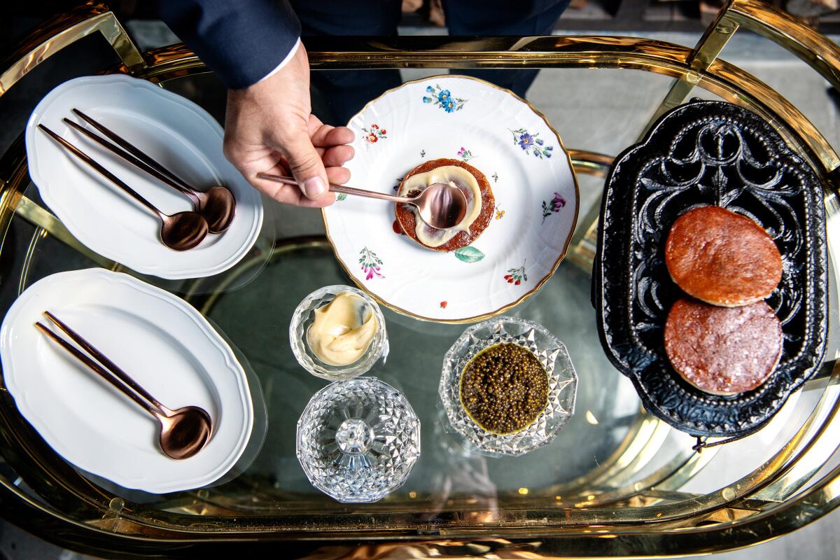 Caviar with banana pancake is assembled tableside at Angler