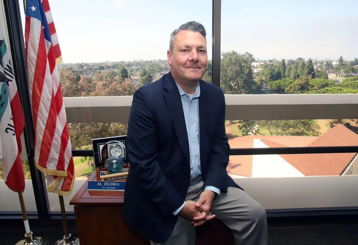 Huntington Beach's City Manager Al Zelinka sits in his office at City Hall on Monday.