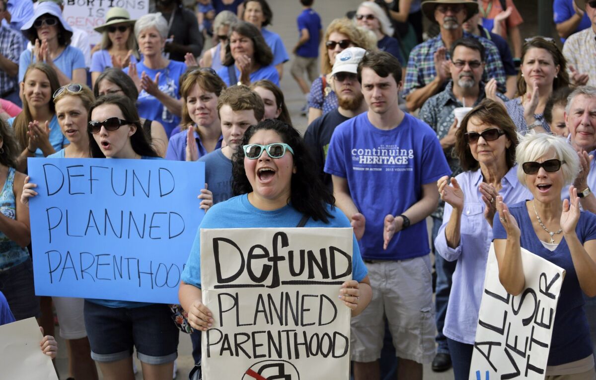 Erica Canaut, center, cheers July 28 as she and other anti-abortion activists rally on the steps of the Texas Capitol in Austin, Texas, to condemn the use in medical research of tissue samples obtained from aborted fetuses.