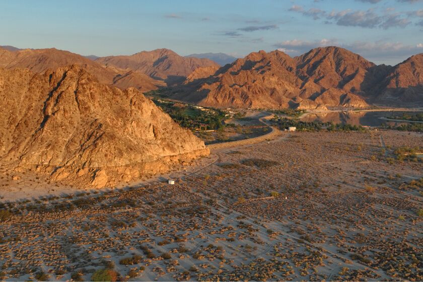 La Quinta, California-Sept. 14, 2022-A large wave pool / surf park is planned for Coral Mountain in La Quinta, California. Local residents are concerned about the development. Coral Mountain (left front) is lite by the morning sun on Sept. 14, 2022. (Carolyn Cole / Los Angeles Times)