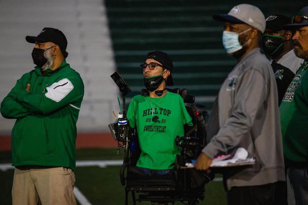 Rob Mendez along with fellow Hilltop High School coaches watch the junior varsity team practice.