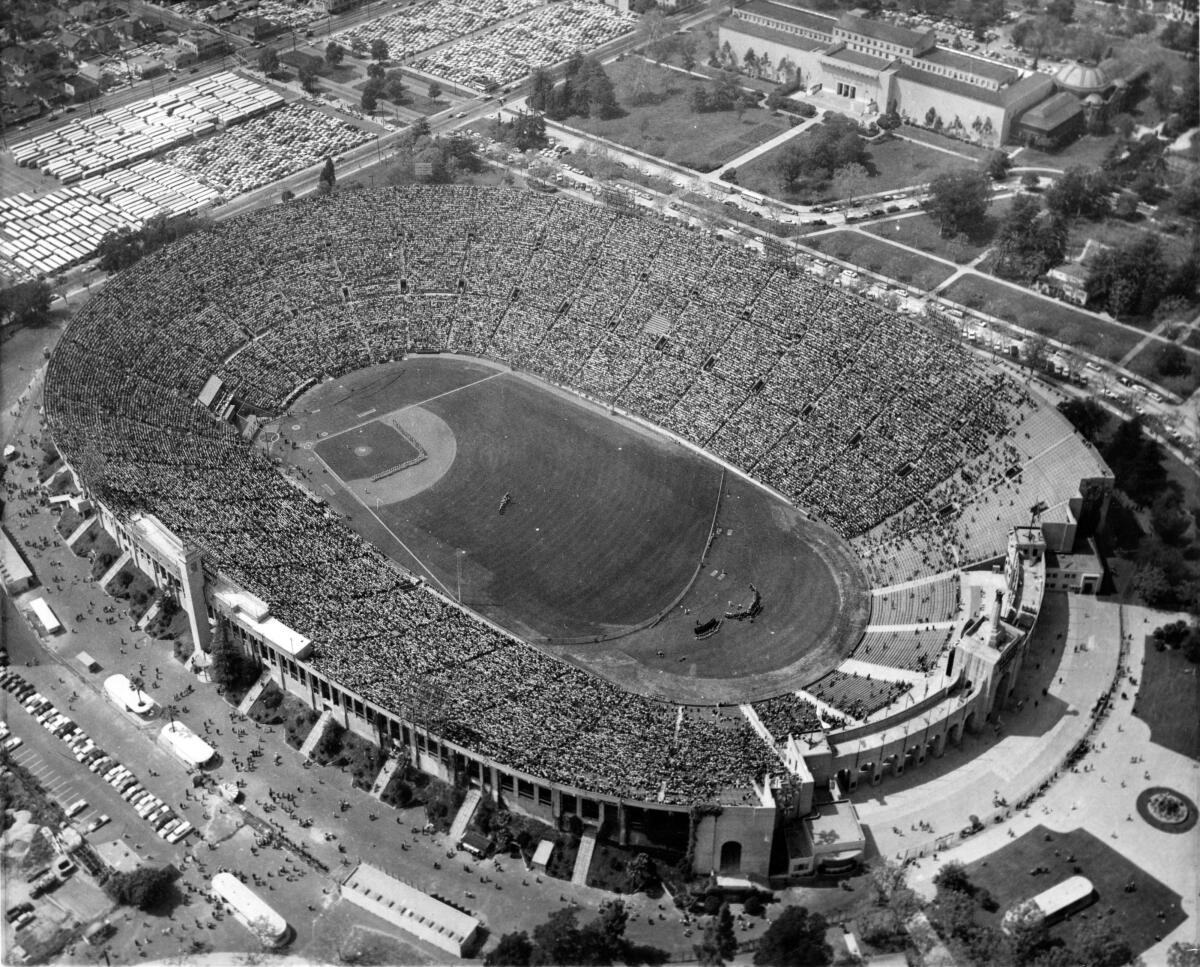 An aerial photo of the Coliseum during opening ceremonies for the first Dodgers game played in Los Angeles.