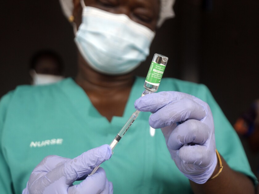 FILE - In this Friday, March 12, 2021 file photo, a nurse prepare one of the country's first coronavirus vaccinations, using the AstraZeneca vaccine manufactured by the Serum Institute of India and provided through the global COVAX initiative, at Yaba Mainland hospital in Lagos, Nigeria. Although the AstraZeneca vaccine produced in Europe has been authorized by the continent’s drug regulatory agency, the same shot manufactured in India by the world’s biggest vaccine maker has not been given the green light. The EU regulator says the drugmaker hasn't completed the necessary paperwork on the Indian manufacturing site, including detail on its production practices and quality control standards. (AP Photo/Sunday Alamba, file)