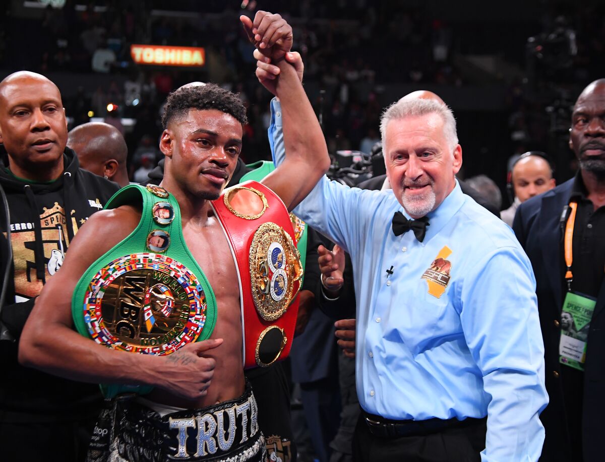 Referee Jack Reiss in in the ring with Erroll Spence Jr. after he defeated Shawn Porter (not pictured) in their IBF & WBC World Welterweight Championship fight at Staples Center on Saturday.