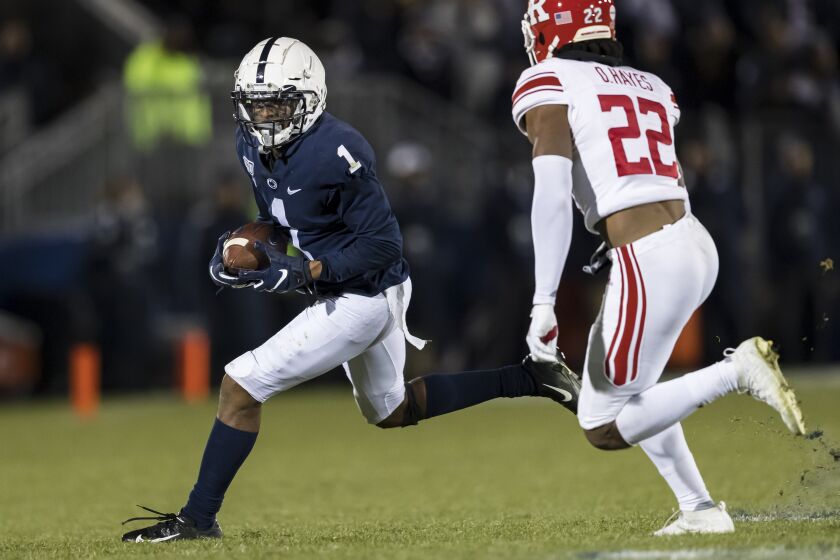STATE COLLEGE, PA - NOVEMBER 30: KJ Hamler #1 of the Penn State Nittany Lions carries the ball as Damon Hayes #22 of the Rutgers Scarlet Knights defends during the second half at Beaver Stadium on November 30, 2019 in State College, Pennsylvania. (Photo by Scott Taetsch/Getty Images)
