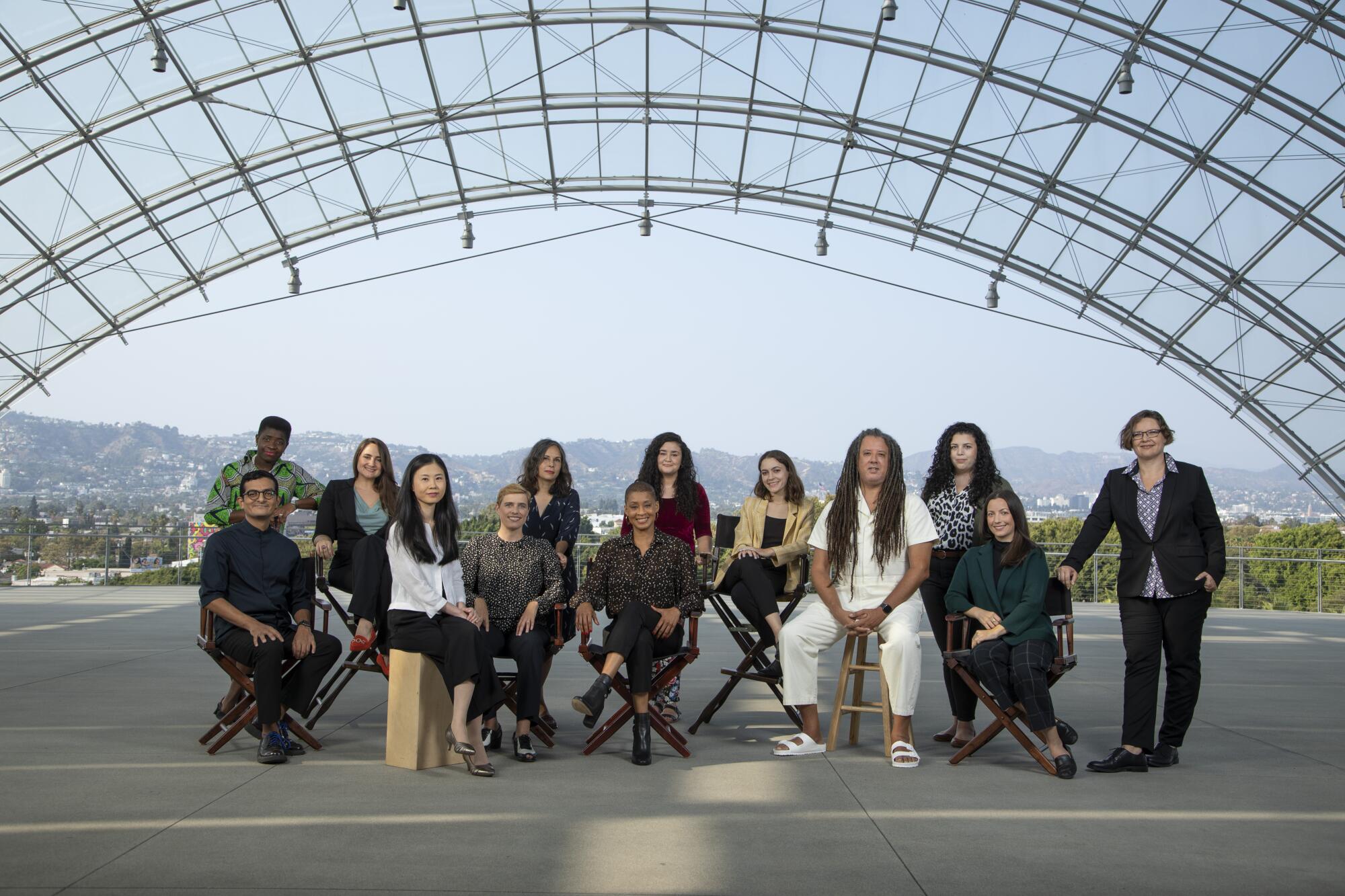 The 13 curators at the Academy Museum, photographed under the glass dome of the new viewing terrace. 