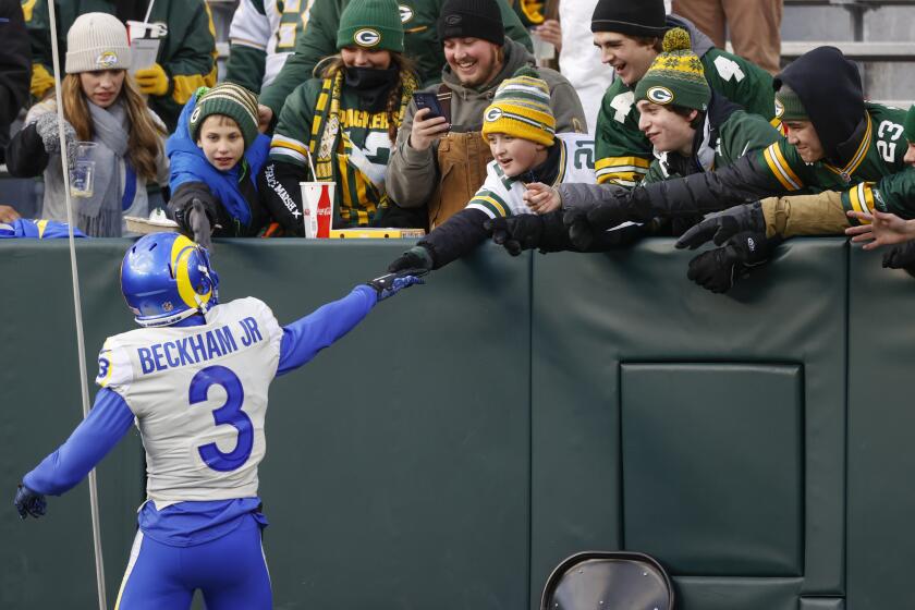 Los Angeles Rams wide receiver Odell Beckham Jr. (3) greets fans before an NFL football game against the Green Bay Packers Sunday, Nov 28. 2021, in Green Bay, Wis. (AP Photo/Jeffrey Phelps)