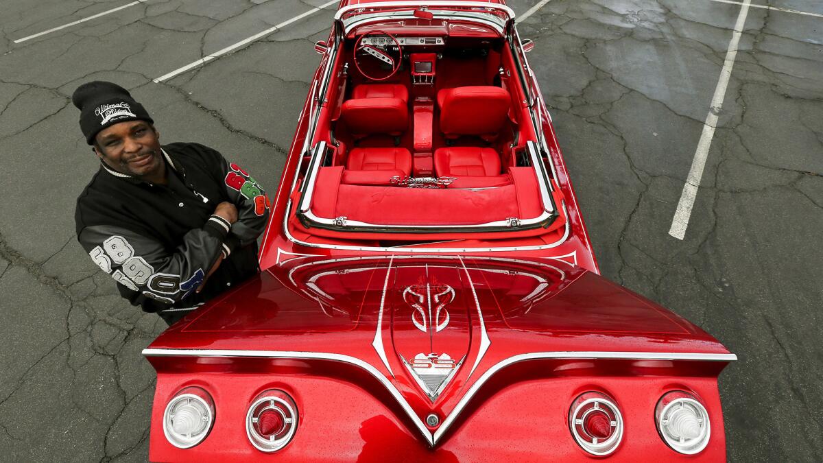 Vernon Maxwell and his 1961 convertible Chevy Impala lowrider.