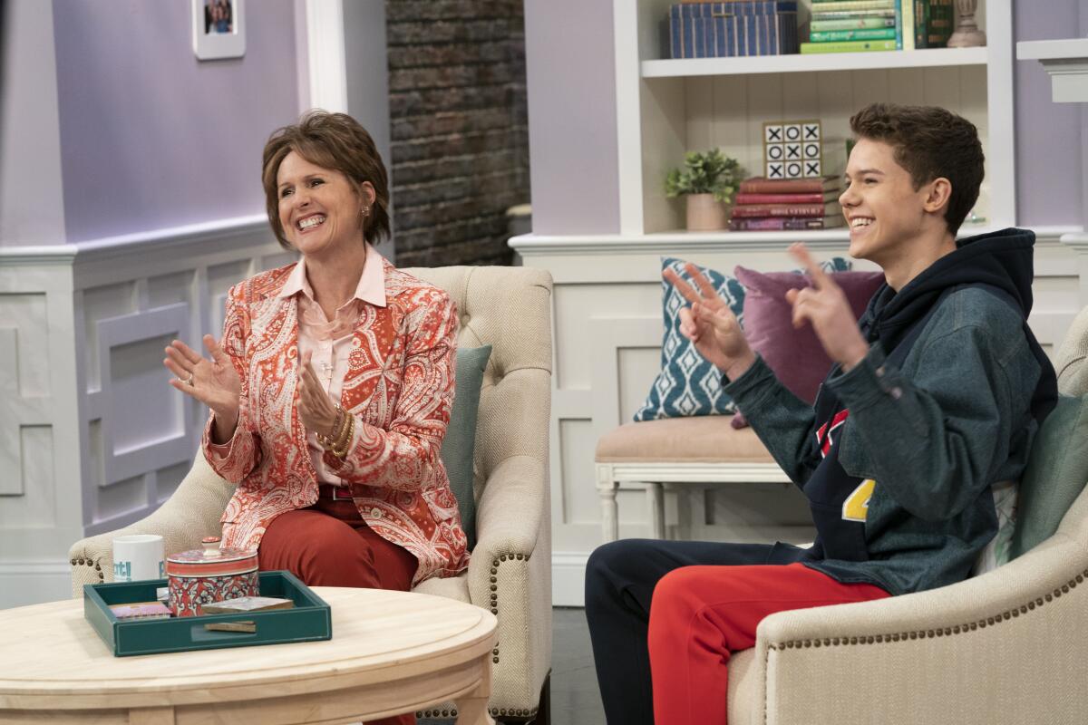 A woman and her teenage son on a talk show set