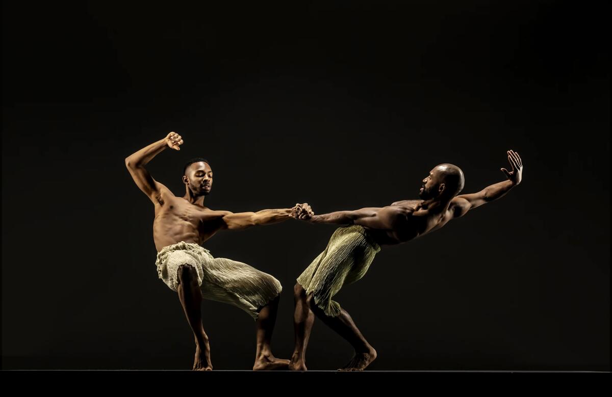 Two shitless men dance onstage. 