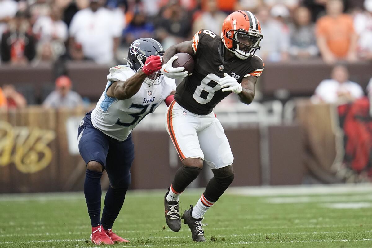 Cleveland Browns wide receiver Elijah Moore is pursued by Tennessee Titans safety Kevin Byard.
