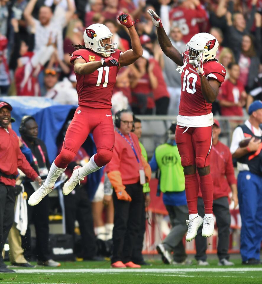 Arizona Cardinals receivers Larry Fitzgerald (11) celebrates his touchdown pass with Chad Williams against the Rams in the second quarter at State Farm Stadium on Sunday.