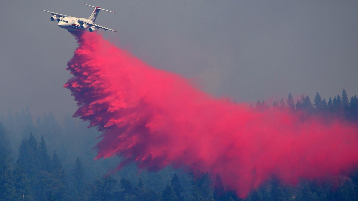 An air tanker drops fire retardant on a hillside ahead of the King fire Wednesday in Pollock Pines, Calif.