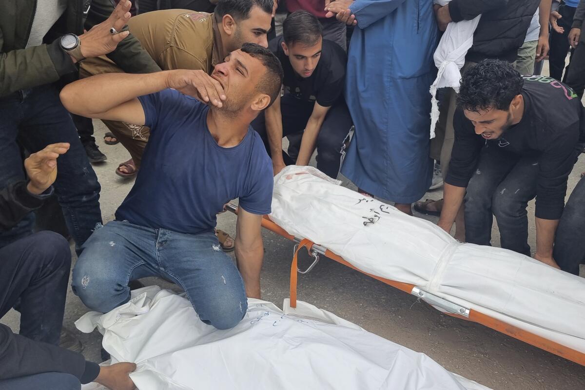 Mourners carry the bodies of members of the Abu Taha family killed in an Israeli airstrike.