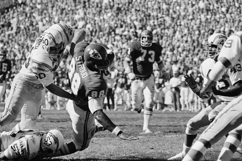 San Diego’s Mel Rogers, 53, and Bob Babich (60) team up high and low an to bring down Kansas City’s Morris Stroud on the 50-yard line after Stroud had caught a pass—good for 18 yards from Len Dawson in game at Kansas City, on Sunday, Oct. 11, 1971. The chiefs beat the Chargers, 31-10. (AP Photo/WPS)