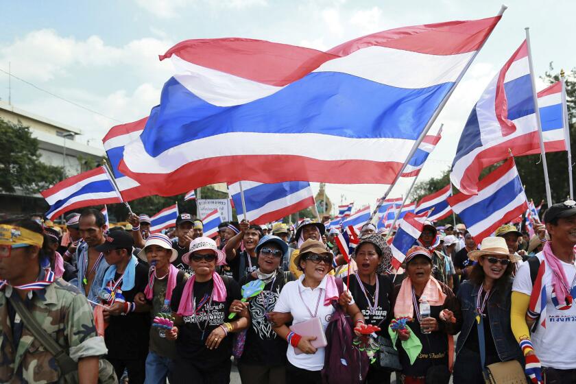 Anti-government protesters march to the Defense Ministry in Bangkok, Thailand, on Thursday.