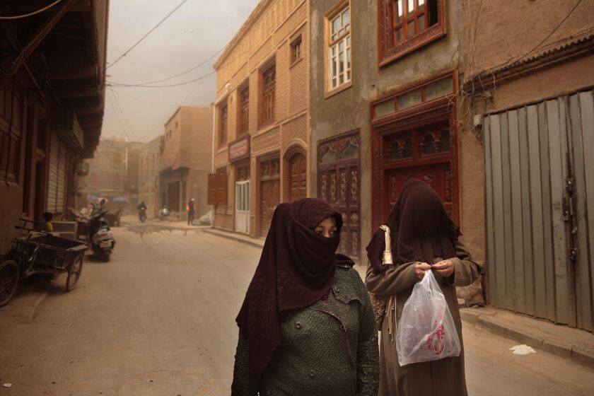 Muslim women in Kashgar, China. Women in the far northwestern city are allowed to cover their heads but not their faces. Kashgar is considered the heartland of the Uighurs, an ethnic Muslim group.