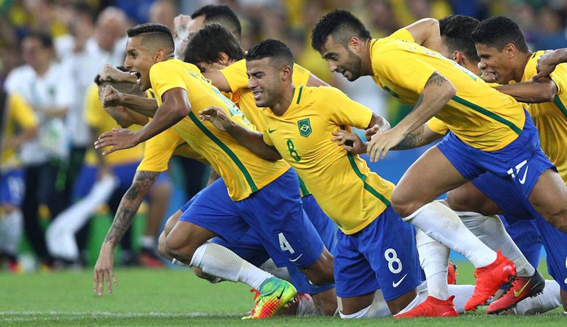 Brazil players celebrate as Neymar of Brazil scores the winning penalty in the penalty shoot out during the Men's Football Final between Brazil and Germany at the Maracana Stadium.