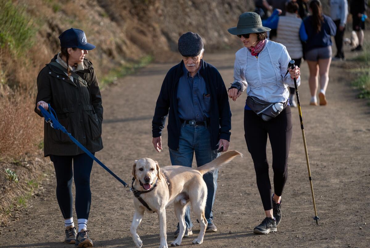 Pete Teti is hiking with his buddies Kori Bernards, left, and her dog Lucca, and Annette Sikand, right, in Griffith Park.