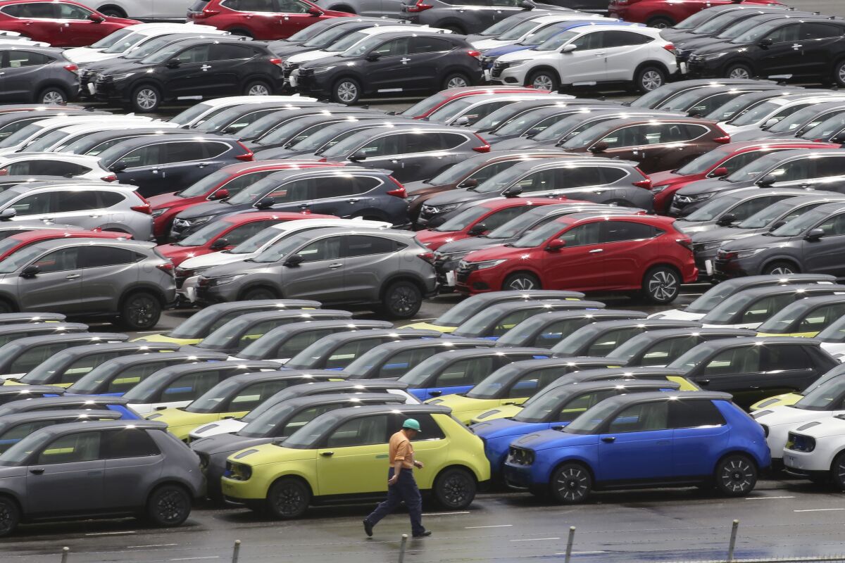 Cars for export park at a port in Yokohama, near Tokyo on July 6, 2020. Japan recorded a trade deficit in April as imports ballooned 28% as energy prices soared following the war in Ukraine, according to Ministry of Finance data released Thursday, May 19, 2022. (AP Photo/Koji Sasahara)