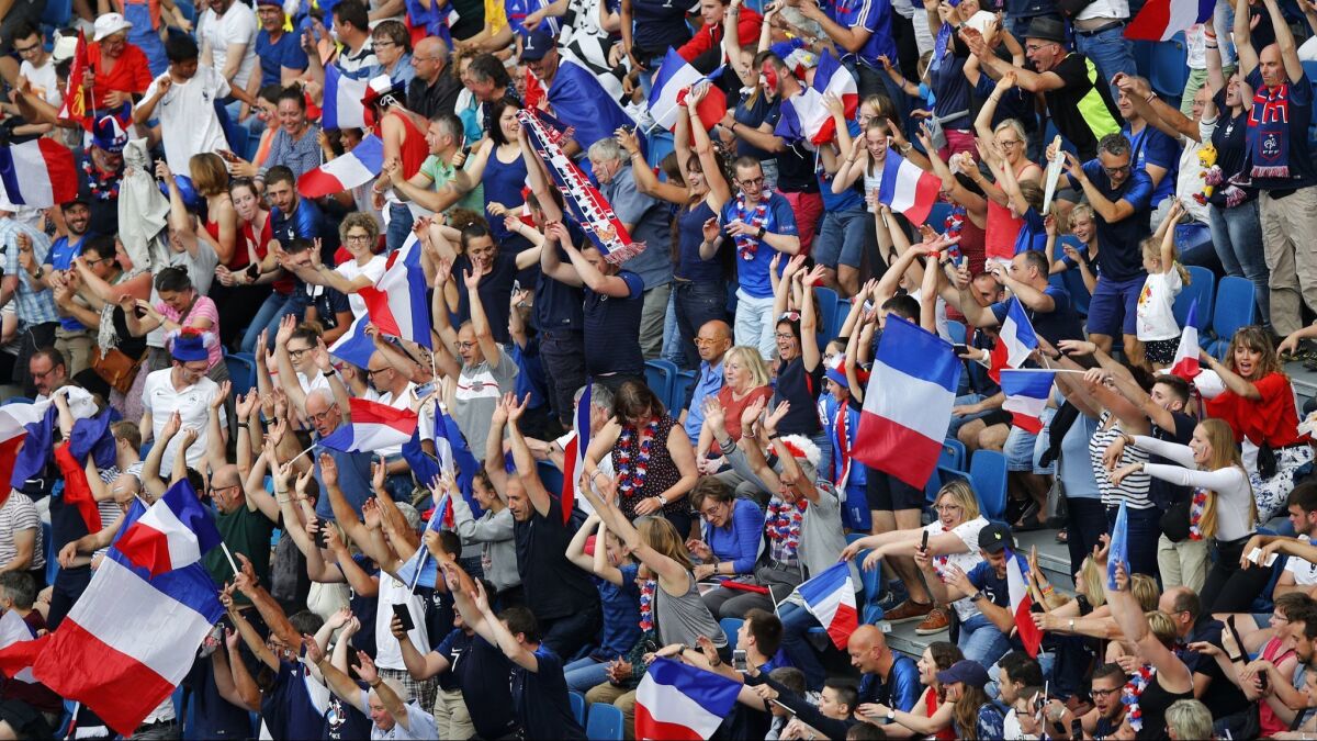 French fans show support for their team during the Women's World Cup. France will play the United States in a quarterfinal match Friday.