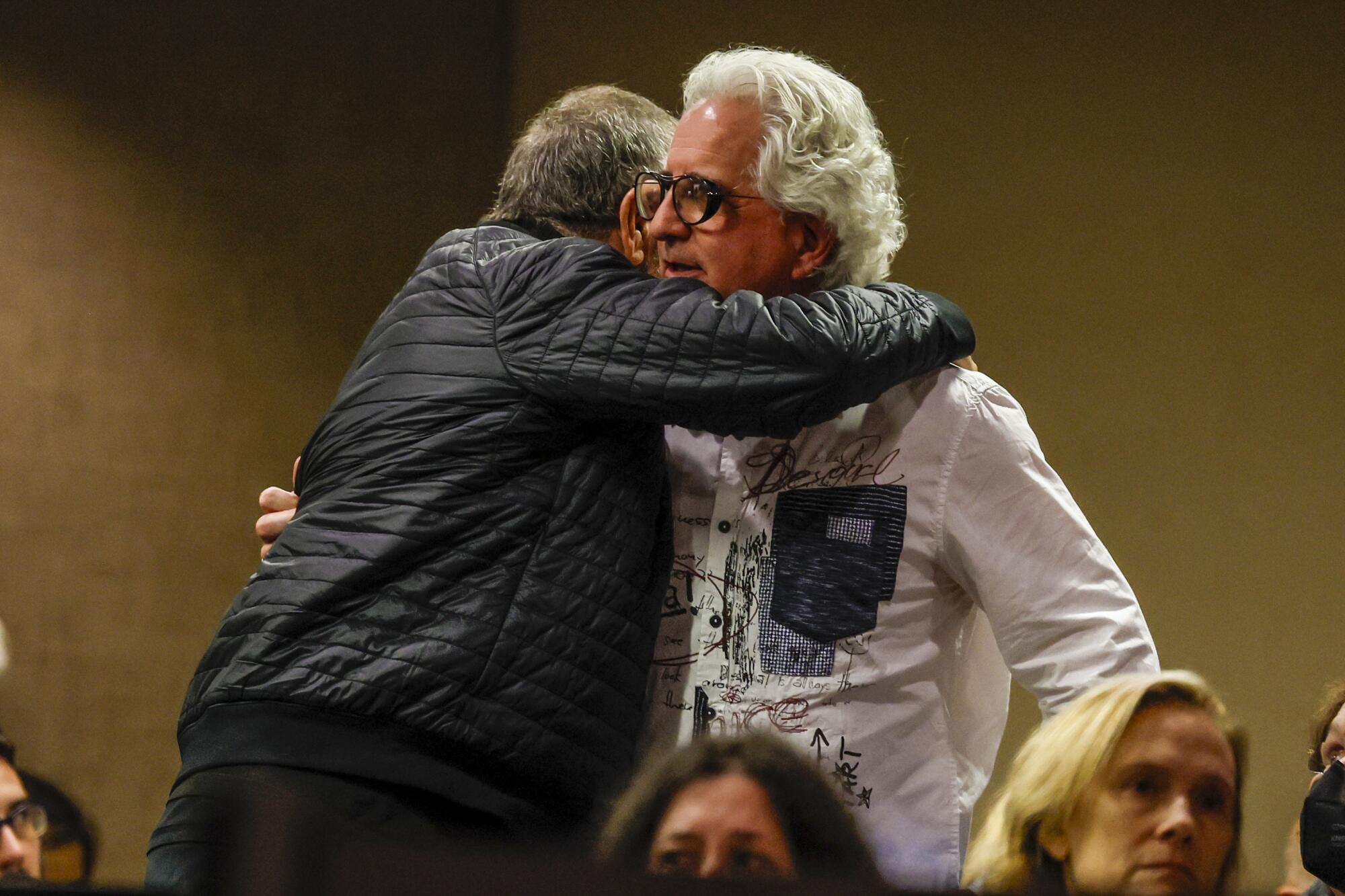 Filmmaker Michel Shane is hugged after offering his about dangerous traffic on Pacific Coa