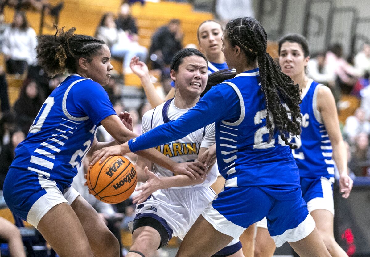Marina's Tiana To, battles against Lompoc's Jalisa Dixon, left, and Cierra Bailey on Tuesday.