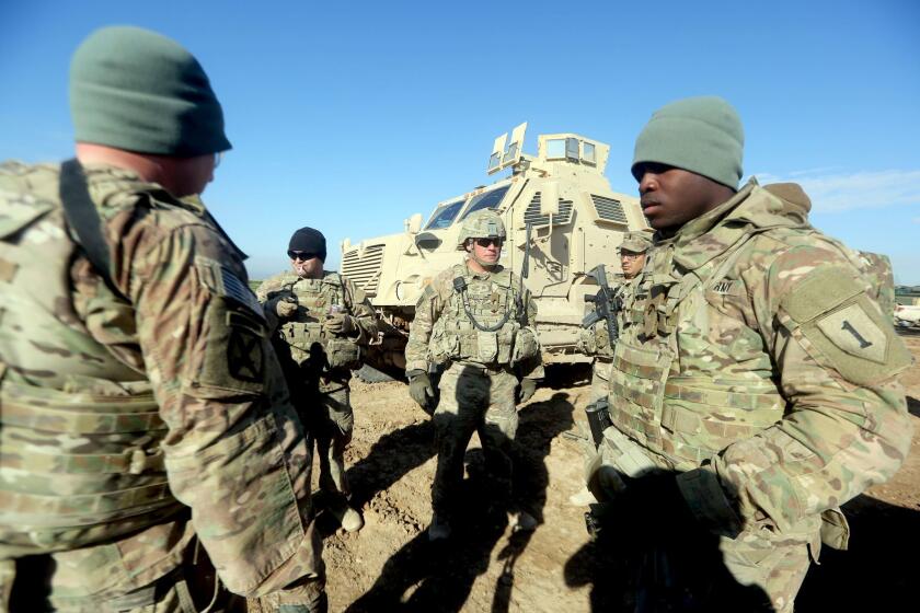 (FILES) This file photo taken on January 26, 2016 shows US soldiers speaking as they train Iraq's 72nd Brigade taking part in a live-fire exercise in Basmaya base, southeast of the Iraqi capital, Baghdad. The United States is prepared to send more troops to Iraq to advise and train for an upcoming offensive on the Islamic State group stronghold of Mosul, a US official said. IS seized Mosul along with other areas in June 2014, but the country's forces have since regained significant ground from the jihadists and are readying for a drive to retake Iraq's second city. / AFP PHOTO / AHMAD AL-RUBAYEAHMAD AL-RUBAYE/AFP/Getty Images ** OUTS - ELSENT, FPG, CM - OUTS * NM, PH, VA if sourced by CT, LA or MoD **
