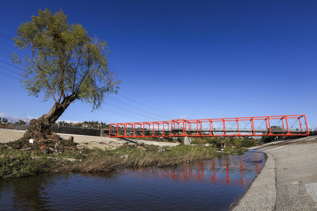 The boxy, orange Taylor Yard Bridge spans the Los Angeles River.