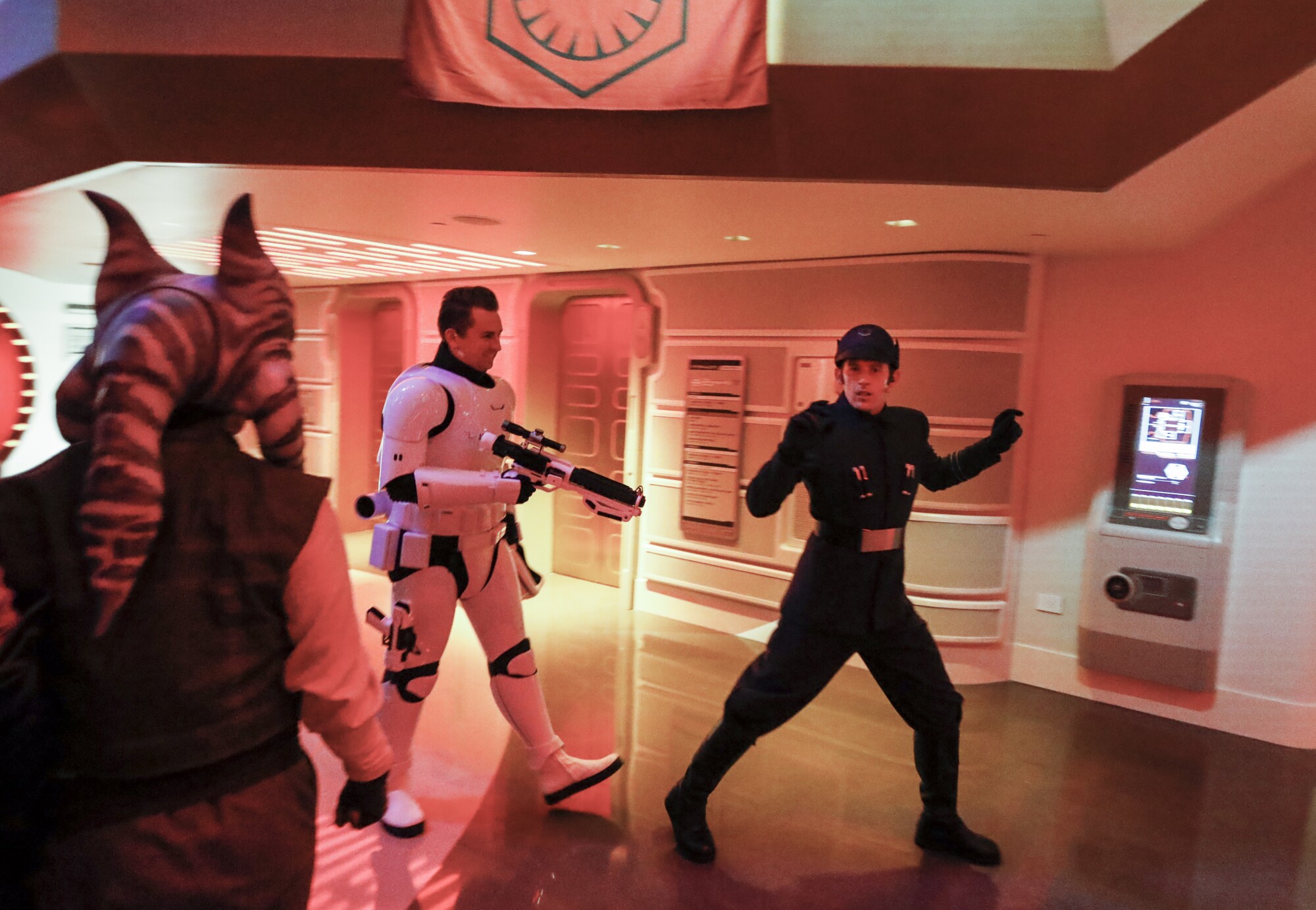 Sammie, the ship's mechanic, left, leads the First Order commander to the brig.