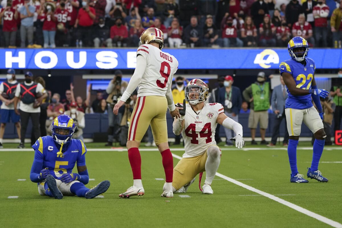 San Francisco 49ers kicker Robbie Gould (9) celebrates with fullback Kyle Juszczyk (44) after making a field goal in overtime of an NFL football game against the Los Angeles Rams, Sunday, Jan. 9, 2022, in Inglewood, Calif. Rams cornerback Jalen Ramsey (5) and defensive back David Long (22) react. (AP Photo/Marcio Jose Sanchez)