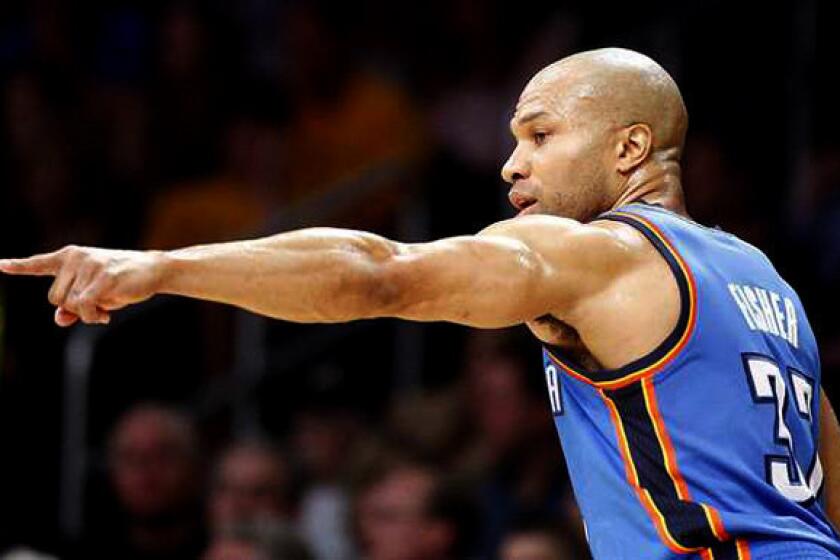 Former Lakers point guard Derek Fisher directs the offense for the Oklahoma City Thunder during a game last season at Staples Center.