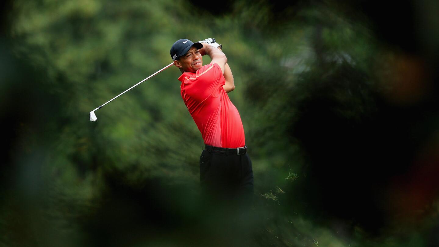 Tiger Woods hits an approach shot on the fifth hole during the final round of the Masters at Augusta National Golf Club on April 12, 2015.