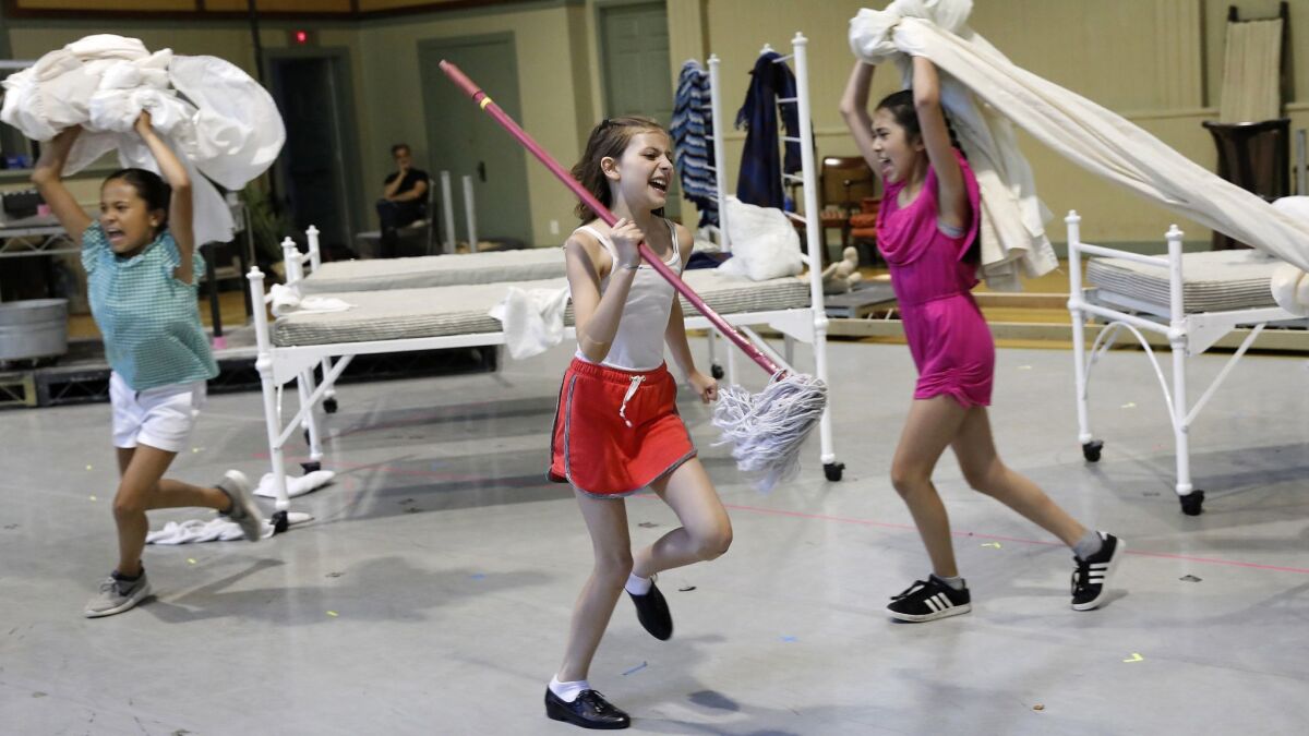 Rae Martinez as Tessie, right, Kaylin Hedges as Annie and Olivia Zenetlis as Duffy rehearse a scene for the upcoming Hollywood Bowl production of "Annie."